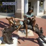 Buy cheap Custom Life Size Bronze statues of companions sitting on arched tree trunks reading together from wholesalers