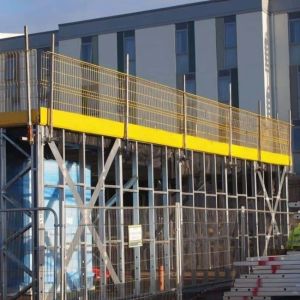 Sloped Surface Edge Protection Barrier With Adjustable Leg Extensions