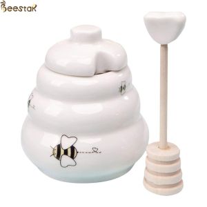 Buy cheap Wholesale White Empty Honey Jar Ceramic Honey Pot with wooden dipper for honey storage from wholesalers