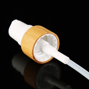 China Clear Lid Cosmetic Lotion Pump With Bamboo Pump Shell on sale